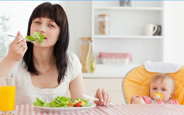 Young mother eating salad