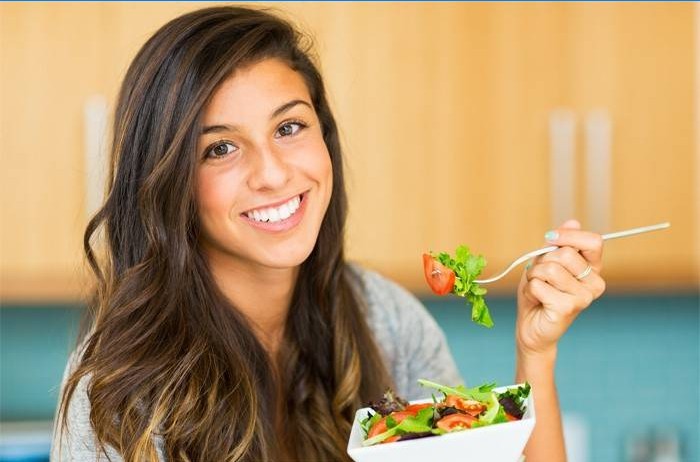 Girl eats vegetable salad