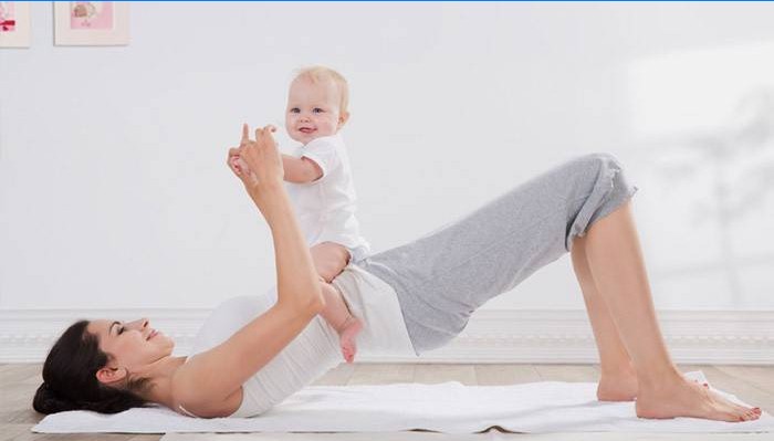 Young mother does exercise with her baby