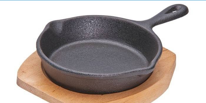 Cast iron frying pan on a wooden stand