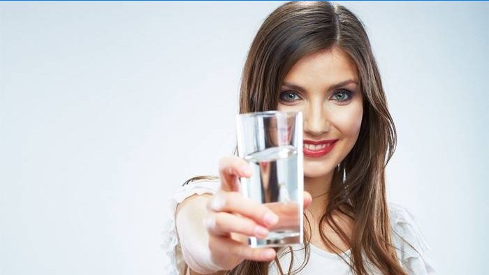 Woman holds a glass of water