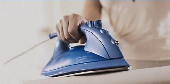 Girl ironing a product