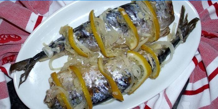 Mackerel with lemon and onions on a dish