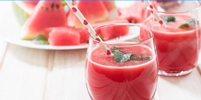Smoothies in glasses and slices of watermelon