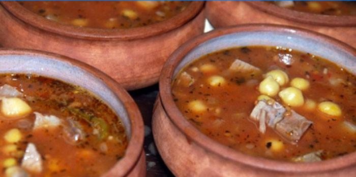 Soup with chickpeas and lamb in clay pots