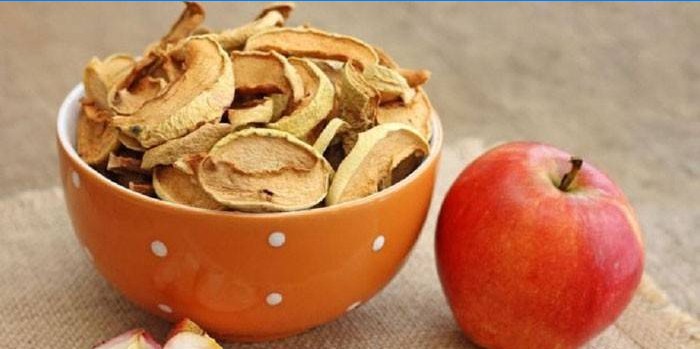 Dried apples in a bowl and fresh fruit