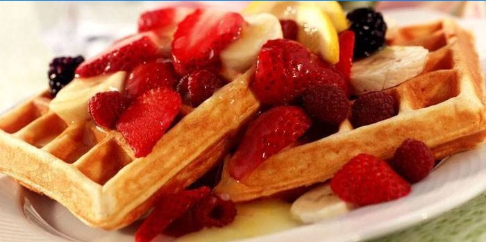 Ready-made soft Belgian waffles with fruits and berries