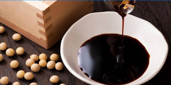 Soy sauce in a plate and soy beans