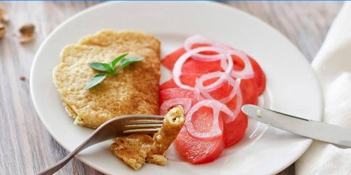 Omelet with tomato salad cooked in a dry pan