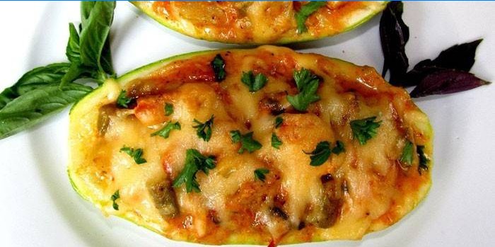 Baked zucchini half with cheese and vegetable filling