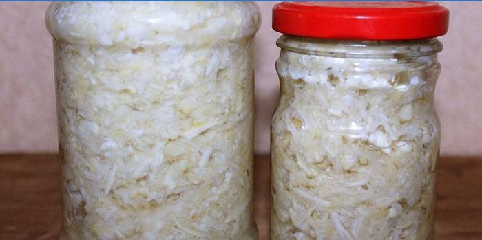 Grated pickled horseradish in jars