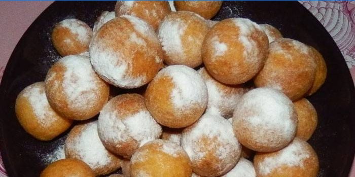 Small donuts topped with icing sugar