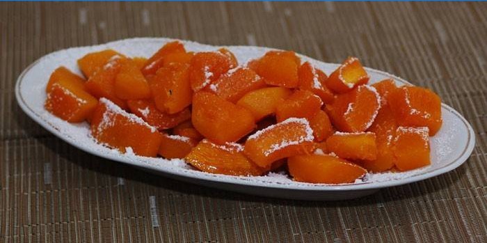 Baked pumpkin slices in icing sugar on a dish