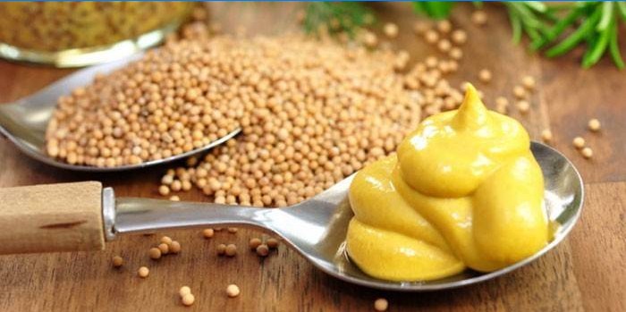 Mustard in a spoon and mustard seeds