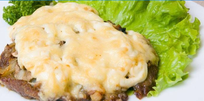 Baked meat with mushrooms and cheese