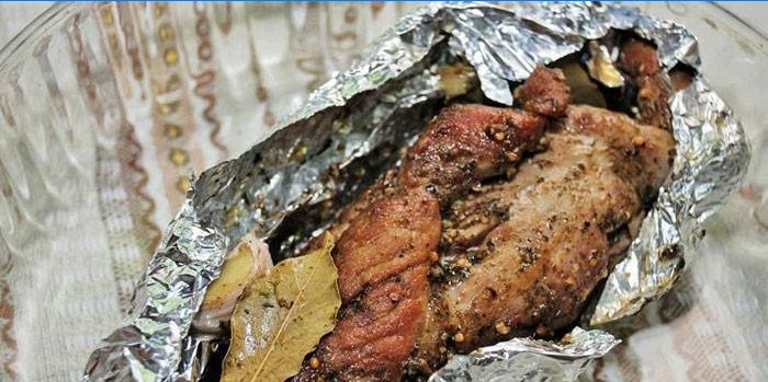 Roasted meat with spices in foil