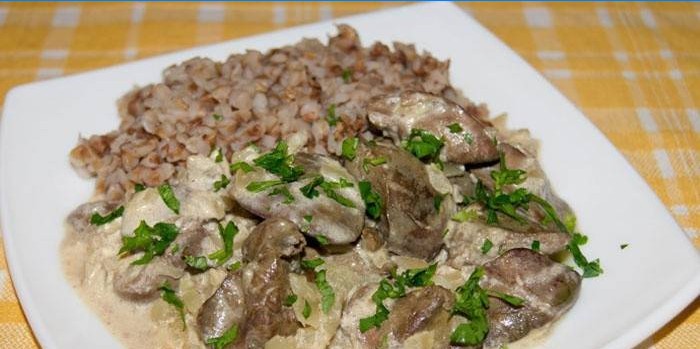 Plate with buckwheat porridge and liver in sour cream sauce