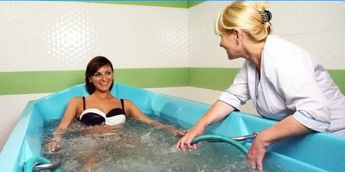 Girl on the procedure of underwater massage
