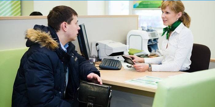 A man talks with a consultant at Sberbank