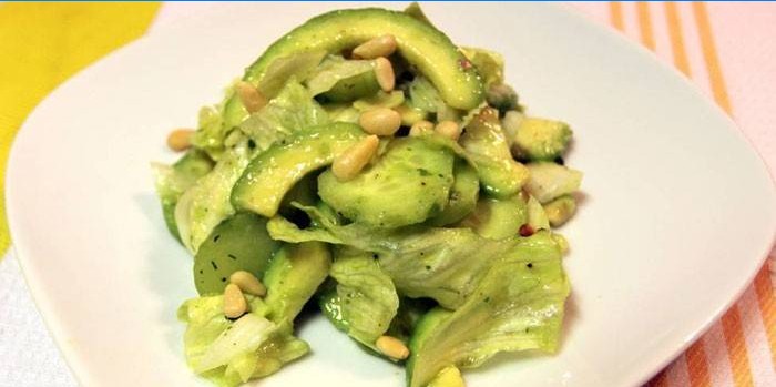 Salad with avocado, lettuce and pine nuts