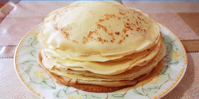 A pile of thin pancakes on a dish