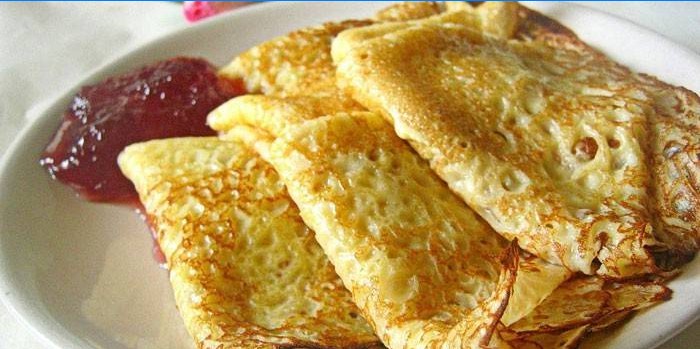 Pancakes with raspberry jam holes