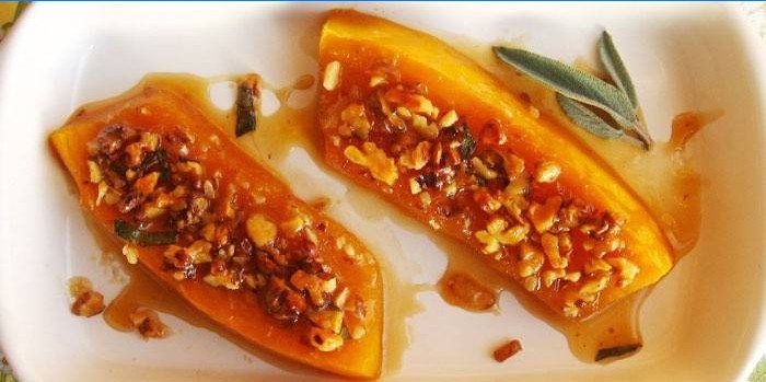 Baked slices of pumpkin in honey sprinkled with nuts