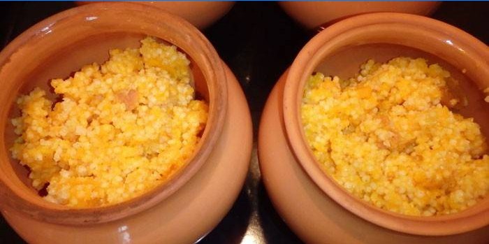 Millet porridge in milk with pumpkin in pots
