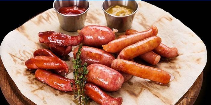 Grilled homemade sausages with sauces