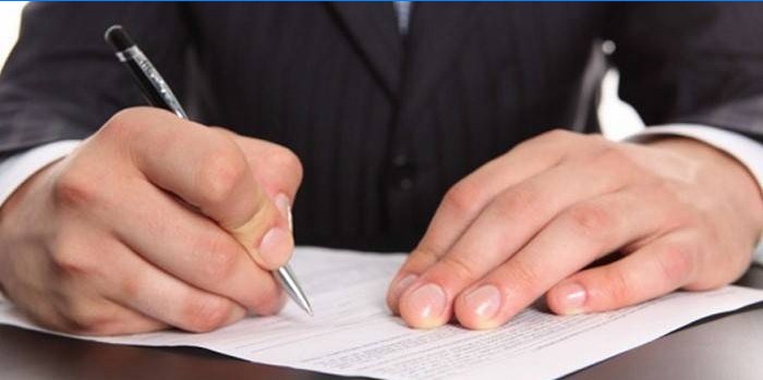 Man signs a document