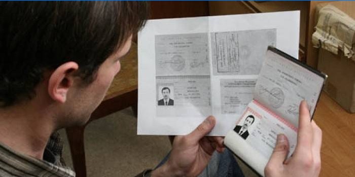 Passport and photocopy in the hands of a man