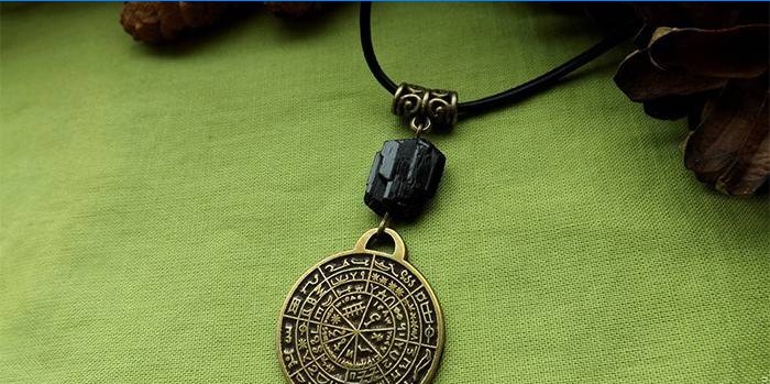 Amulet with magic inscriptions on a lace