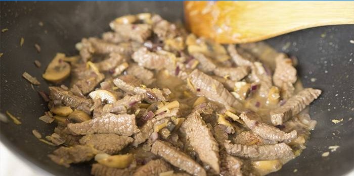Meat with onions in a pan
