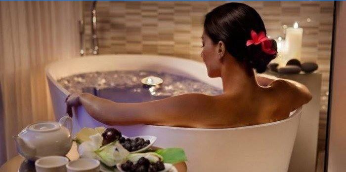 Girl takes a bath with herbs