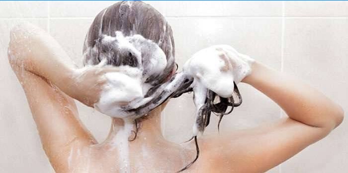 Woman washes hair