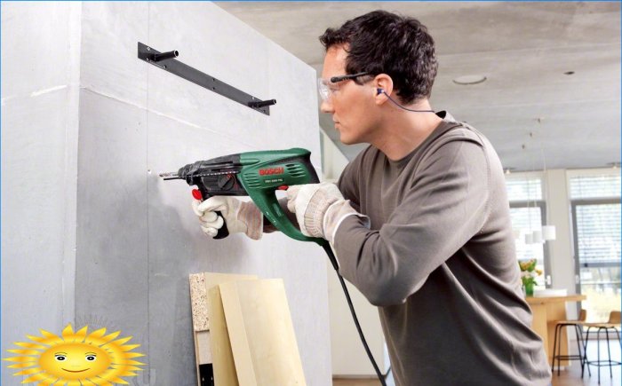 Drilling a hole in the wall with a hammer drill