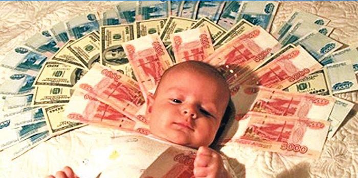 Baby lies on banknotes