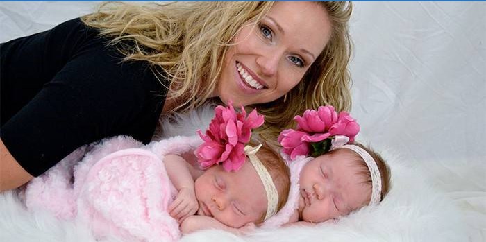 Woman with twin newborn girls