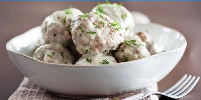 Meatballs in a sour cream sauce on a plate