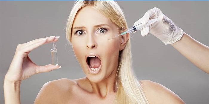 A girl with an ampoule in her hand makes an injection in the face