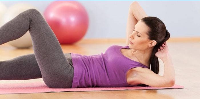 Girl doing abs exercise lying on her back