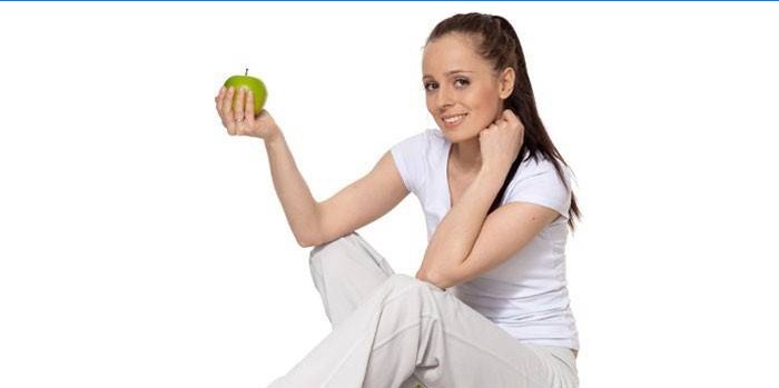 Girl holds apple in hand