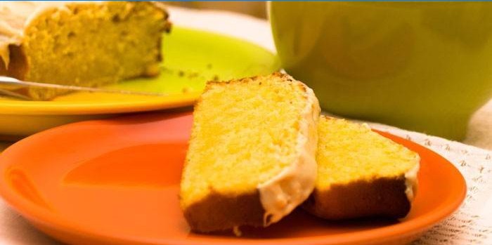 Two slices of lemon cake with icing on a plate