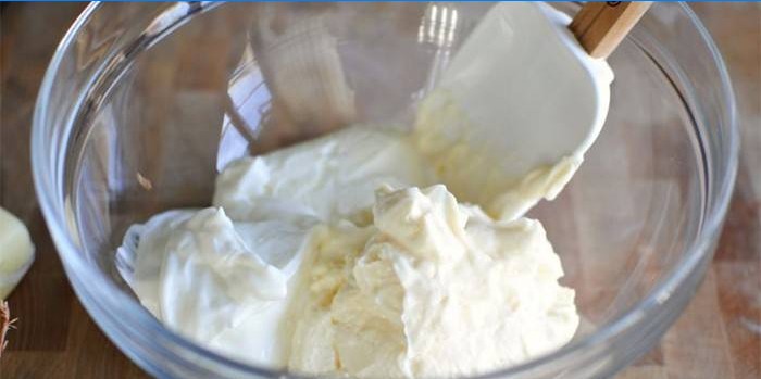 Sour cream and curd cheese in a glass bowl