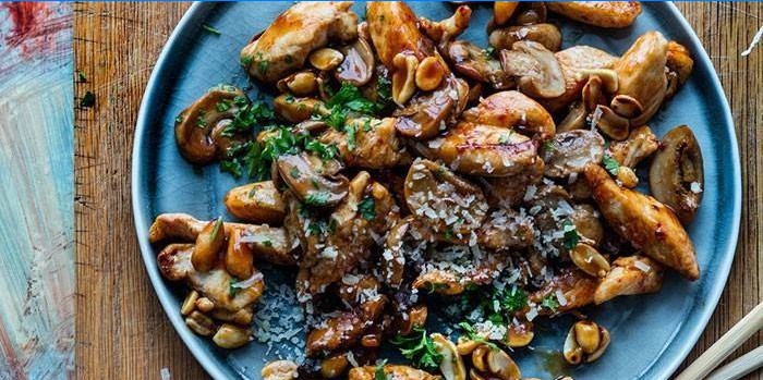 Chicken meat with mushrooms and nuts.
