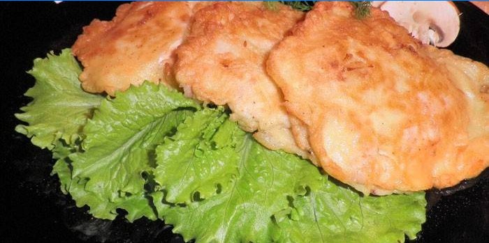 Three chicken fillet chops on a plate with lettuce
