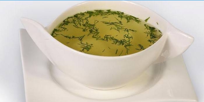 Chicken stock with greens in a plate