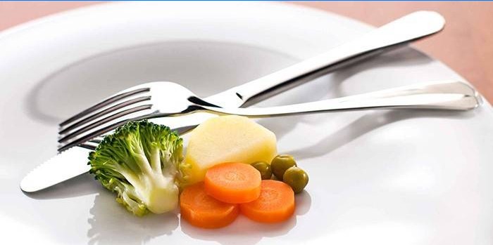 Plate with a small portion of vegetables and cutlery