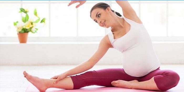 Pregnant girl doing pilates at home
