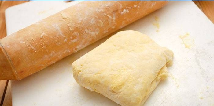 Puff pastry on the table and rolling pin